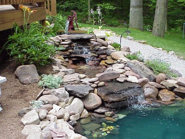 beautiful fountain with natural river look 700x525 634x476 13 Eye Popping Fountains That Are Absolutely A Must For Every Garden
