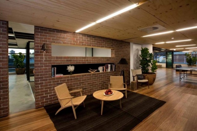 15 Fascinating Accent Brick Walls In The Interior Design That Will Elevate Your Creativity captivating lounge room design ideas in neutral color scheme overlooking with red brick wall partition on black area flooring base and oak arm chairs 915x610 634x423 15 Fascinating Accent Brick Walls In The Interior Design That Will Elevate Your Creativity