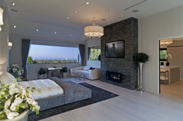 16 Contemporary And Modern Bedroom Designs With TV the master bedroom has a huge fireplace with the tv above it 634x421 16 Contemporary And Modern Bedroom Designs With TV