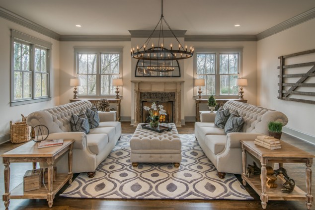 14 Inspirational Ideas To Add Rug In The Living Room awesome geometric area rug plus round chandelier idea and ottoman coffee table also beautiful tufted sofa living room 634x423 14 Inspirational Ideas To Add Rug In The Living Room
