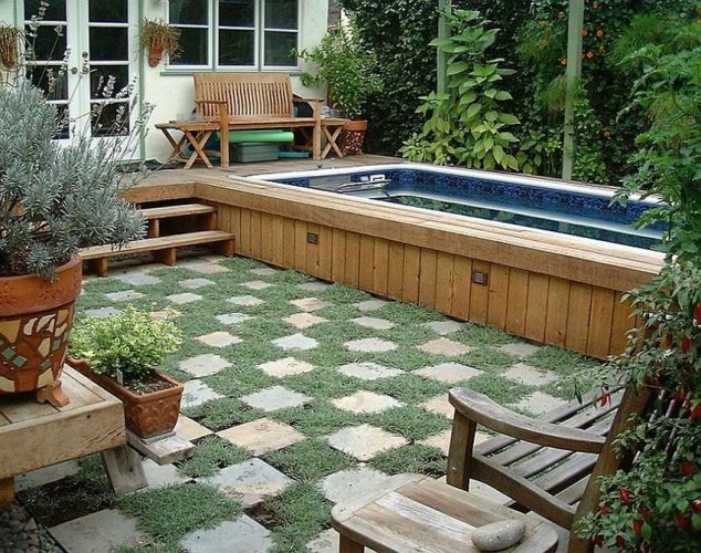 a terrific traditional swimming pool with wooden material and concrete stepping stone sunken n grassy field and classic wooden chairs 634x500 16 Garden And Backyard Swimming Pool Stepping Ideas that You Dream For