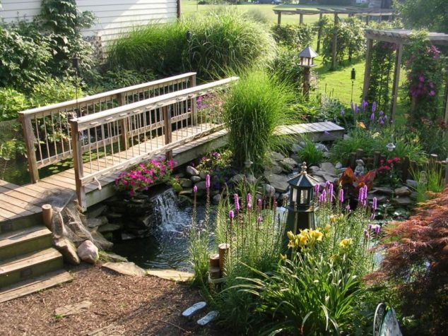 beautiful garden with wooden bridge near pond plus decorative lantern and pergola 634x476 15 Inspirative Garden Pond With Bridge That You Would Like To See
