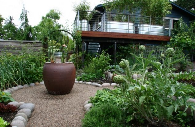 rehab diary eugene oregon garden sone wall galvanized trough planters stone edging pea gravel gardenista 733x477 634x413 15 Creative Garden Edging Ideas For A Better Outdoor Look