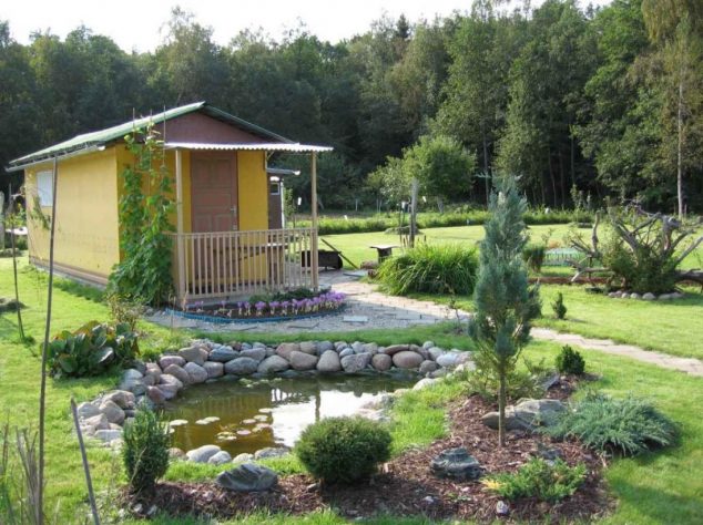 rustic design of a small house with pond in front yard plus garden ideas beside terrace including yellow paiting wall 634x474 15 Cool Under Ground Garden Pond Ideas for Making Favorite Garden