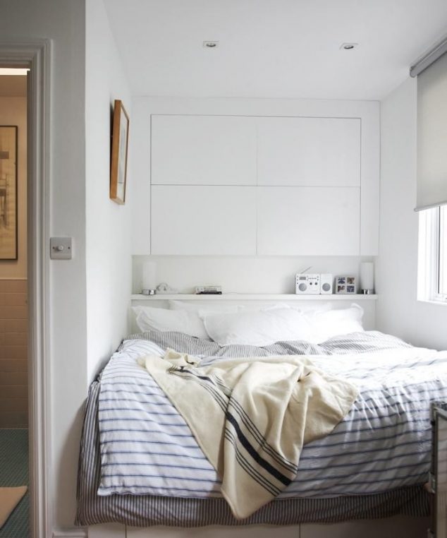Bedroom features a headboard composed of cabinet doors that conceal bookshelves and an easily accessible shelf beneath narrow space bedroom beautiful white interior color bedding 634x762 Make Space In Your Home:13 Space Saving Tricks For Small Apartments