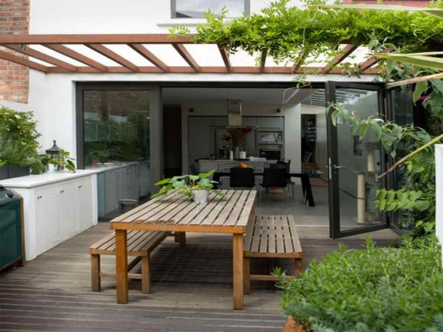 15 Stunning Roof Top Balcony Garden Design That Will Surprise You vintage wooden patio dining table set under canopy plus white outdoor kitchen set 634x476 15 Stunning Roof Top Balcony Garden Design That Will Surprise You