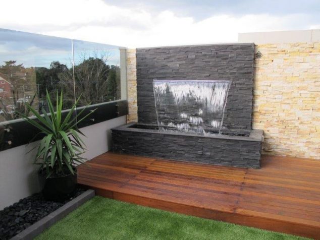12 Stacked Stone Walls That Will Add Charm In Your Home delightful calming effect stone brick how to build a water wall diy easy guide outdoor corner placement above wooden tiles 634x476 12 Stacked Stone Walls That Will Add Charm In Your Home